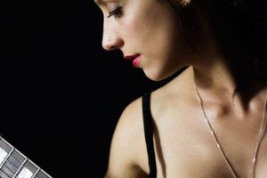 Elegant model shot in studio with guitar